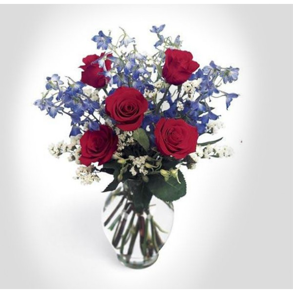 Un bouquet rouge, blanc et bleu éclatant pour décorer votre foyer. Un  arrangement de roses rouges, de delphiniums bleus et de statices blancs  magnifiques, offert dans un vase en verre pour créer